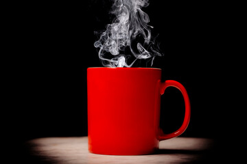 red cup of coffee rest on a marble table on black background with copy space for your text