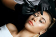 Woman in gloves applying permanent makeup