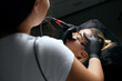 © vpavlyuk - Beauty specialist in gloves applying brow tattoo