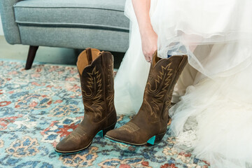 Wall Mural - Closeup shot of a bride wearing boots