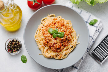 Wall Mural - Traditional italian pasta spaghetti with bolognese meat sauce and parmesan on a light concrete, stone background