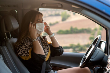 Woman in vehicle interior putting on mask