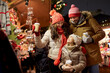 © Syda Productions - family, winter holidays and celebration concept - happy mother, father and little daughter with takeaway drinks at christmas market on town hall square in tallinn, estonia