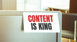© Andrey - Sticky note on the computer. Text CONTENT IS KING