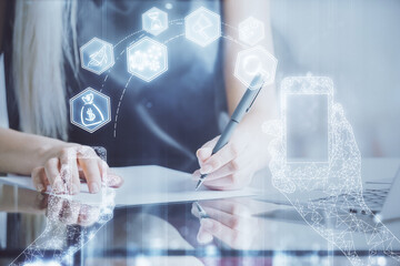 Fototapete - Technology theme hologram over woman's hands taking notes background. Concept of Tech. Double exposure