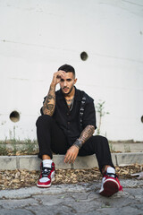 Poster - Vertical shot of a young Caucasian man with tattoos posing