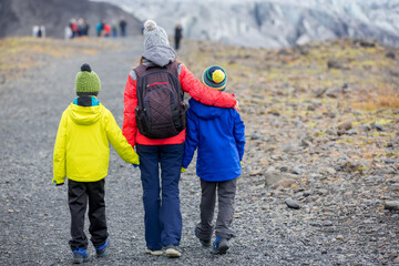 Mother walking with two boys, in beautiful aerial view of the nature in Skaftafell Glacier national park on a gorgeous autumn day