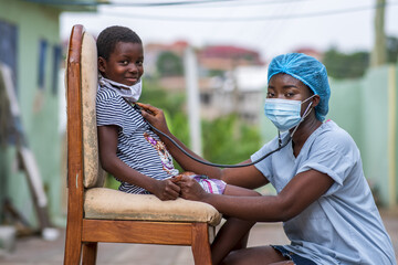 Closeup shot of a boy getting a checkup by a doctor