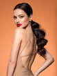 © Valua Vitaly - Beautiful white girl with a red lipstick on lips. Stunning brunette girl with long hair tail.  Closeup face of young beautiful woman with a healthy clean skin. Pretty woman with bright makeup