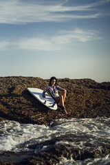 Sticker - Vertical shot of a European female posing with her surfboard