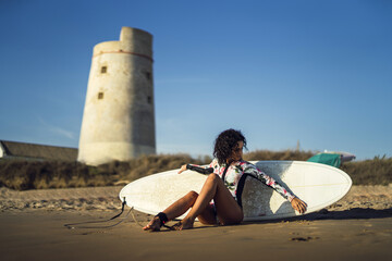 Sticker - Beautiful shot of a European female posing with her surfboard