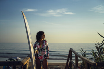 Sticker - Beautiful shot of a European female posing with her surfboard