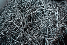 A Pile Of Metal Spirals As Burr Waste In Metal Processing.