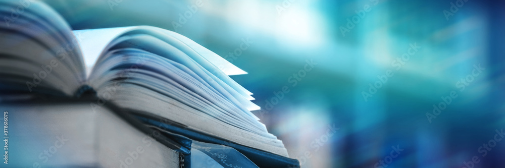 Book stack in the library and blurred bookshelf background for education. education background. back to school concept.