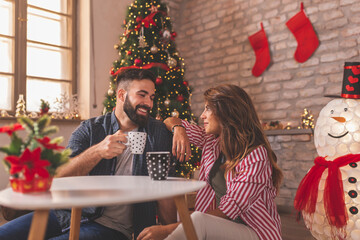 Couple drinking coffee on Christmas morning