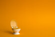 White toilet with an orange lid on an orange background in honor of world toilet day on November 19, which is dedicated to public toilets and their maintenance