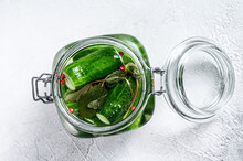 Green Pickle Cucumbers In A Glass Jar. Natural Product. White Background. Top View