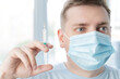 © velirina - Man, adult in face mask in doctor's office is vaccinated. Syringe with vaccine for covid-19 coronavirus,flu,dangerous infectious diseases. Injection after clinical trials for human, child. Medicine