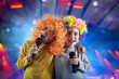 © alphaspirit - Two child sing a song with microphone and funny wig