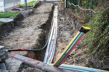 Construction Site For Installing Fiber Optic Cables Under The Ground Beside A Street To Bring Fast Internet To All Residents, Selected Focus