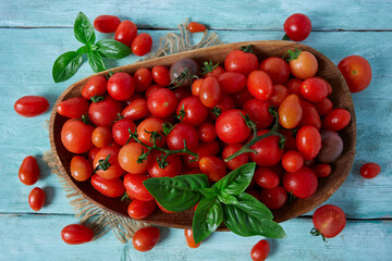 Wall Mural - variety of miniature tomatoes on turquoise wooden surface