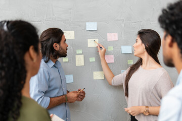 Wall Mural - Professional latin business coworkers discussing sales strategy and planning in co-working open space. Communication, workspace, meeting concept..