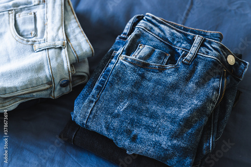 Cuadros en Lienzo organizing your wardrobe, different jeans in various denim colors getting sorted