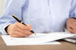 © zhenya - Close-up shot of a pen while viewing documents