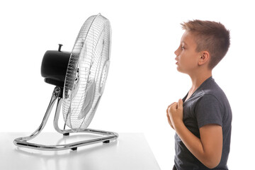 Poster - Little boy enjoying air flow from fan on white background. Summer heat