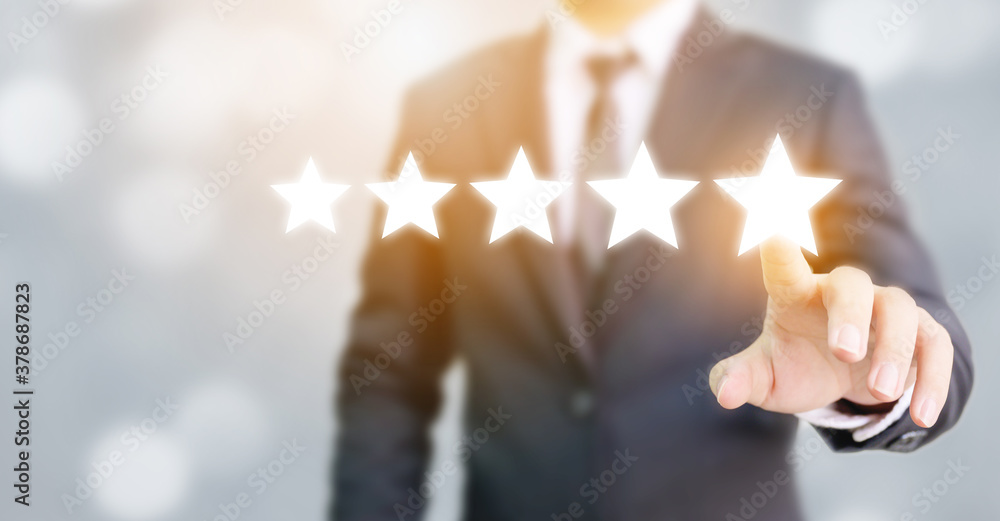 Hand of businessman touching five star symbol to increase rating of company concept - obrazy, fototapety, plakaty 