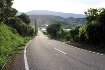 Country road and sunset with mountains as background in Asuka