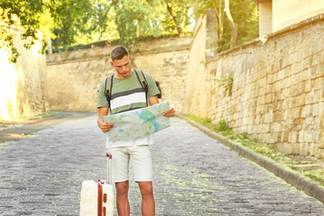 Wall Mural - Male tourist with map on city street