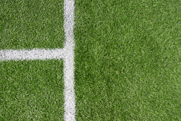 Wall Mural - Green artificial grass turf soccer football field background with white line boundary. Top view