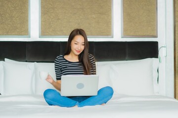 Portrait beautiful young asian woman use computer laptop on bed