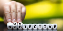 Hand Turns Dice And Changes The Word "subjective" To "objective".