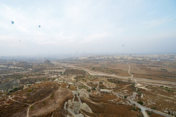 Wall Mural - Colorful hot air balloon ride and tour in Goreme valley, semi-arid region in central Turkey known for its distinctive fairy chimneys, tall, cone-shaped rock formation- Cappadocia, Turkey