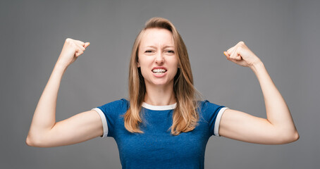 Image of Successful Young female celebrating amazing news, making Winner gesture. Human emotions concept