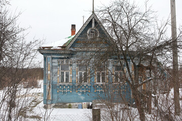 Old traditional national wooden house with richly decorated ornamental carved windows, frames in village (Moscow region, Russia). Russian folk style in architecture, countryside in Russia. Landmark