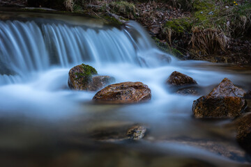 Wall Mural - River water flows among the rocks and forms small waterfalls, Rascafría, Madrid, Spain