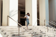 © THESHOTS.CO - University student walk down the stair.