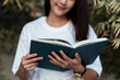 © THESHOTS.CO - University student holding a book.