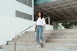 © THESHOTS.CO - University student walking down stair.