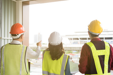 Engineer team discuss and planning from work site about construction building project with blueprint drawing paper and computer laptop