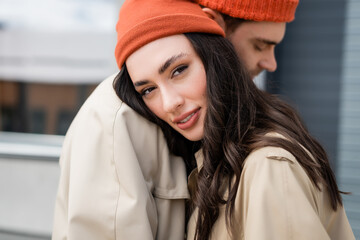 Sticker - selective focus of trendy woman leaning on stylish man and looking at camera