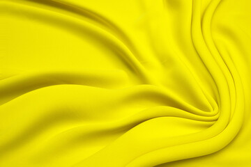 Beautiful smooth elegant wavy light yellow satin silk luxury cloth fabric texture, abstract background design. Copy space