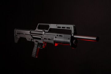 Wall Mural - Modern tactical pump action shotgun on a dark back. Red backlight.