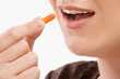 © VisualEyze - Close-up of a patient taking a capsule