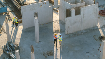 Wall Mural - Aerial Shot of a New Constructions Development Site with Diverse team of Engineers and Architects Discussing Real Estate Projects. Heavy Machinery and Construction Workers are Working in the Area.