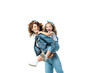 © LIGHTFIELD STUDIOS - side view of mother piggybacking daughter in denim outfit isolated on white