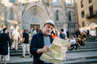 © BullRun - Focused mature male tourist reading map